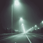 بزرگراه در شب با ردیف چراغ‌های خیابانی LED؛ نور سفید یکنواخت روی سطح جاده در هوای مه‌آلود و بدون خیرگی محسوس.